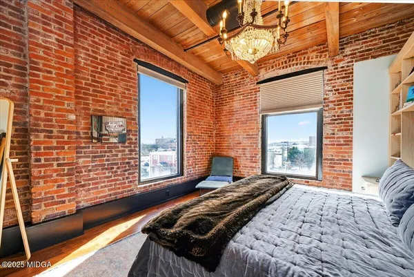 a bedroom with a bed and a large window