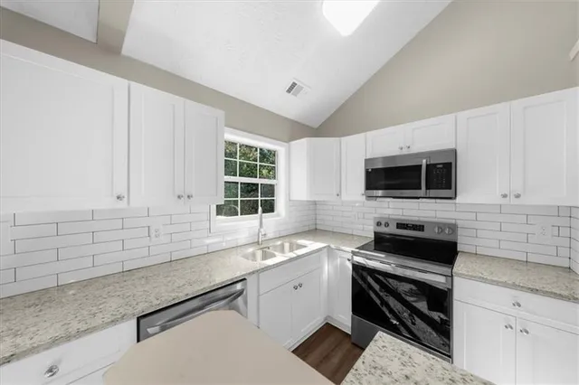 a white bath tub sitting next to a shower