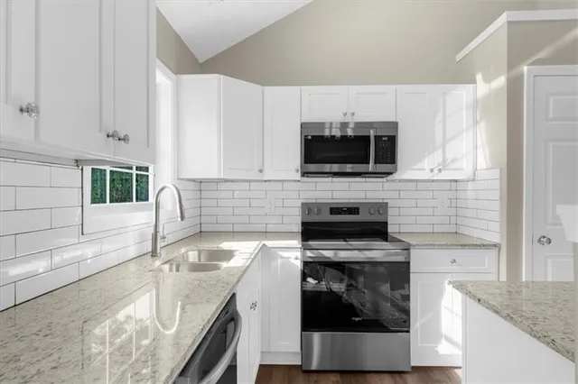 an empty room with a window and a ceiling fan