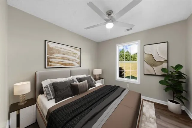 a spacious bedroom with a bed and a window