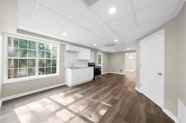 a view of an empty room with wooden floor