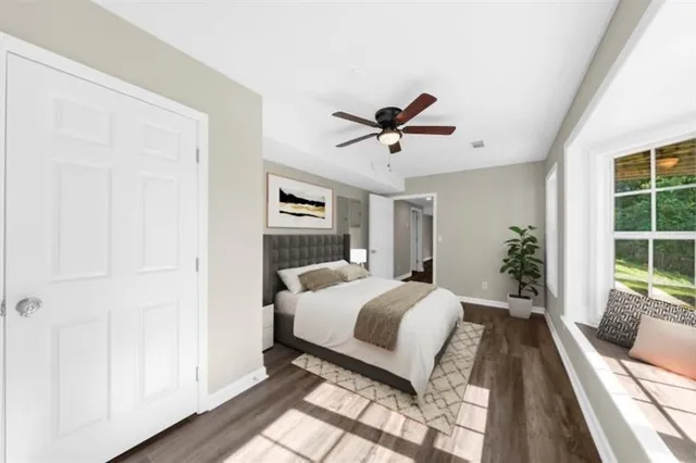 a front view of a house with a garden and yard