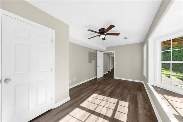 a view of a house with a yard and lawn chairs with a fire pit