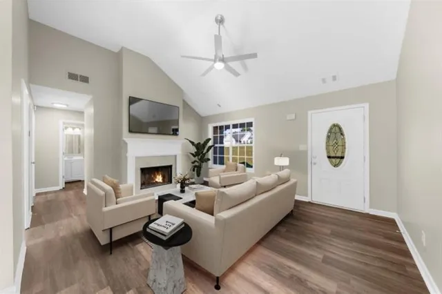 a view of an empty room with window and wooden floor