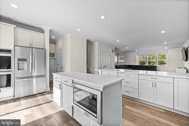a kitchen with a sink stainless steel appliances and cabinets