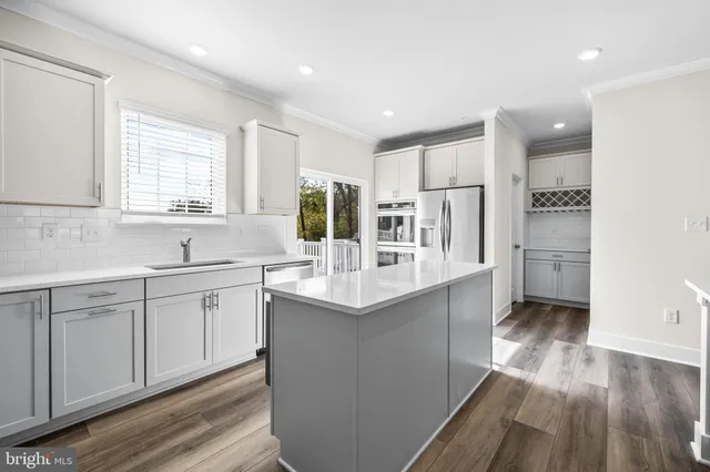 a kitchen with counter top space sink and center island