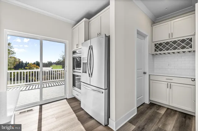 a kitchen with stainless steel appliances a refrigerator sink and cabinets