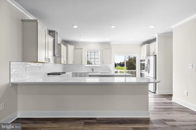 a large kitchen with kitchen island a sink and a stove