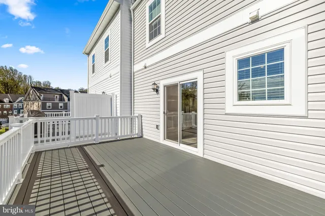 a view of backyard with deck and wooden floor