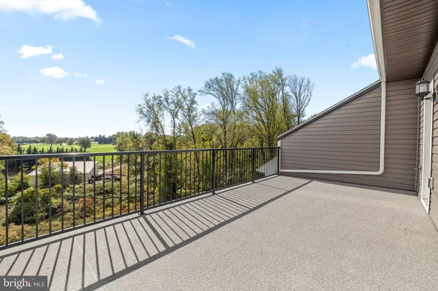 an empty room with wooden floor and furniture