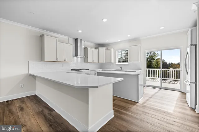 a kitchen with a sink window and cabinets