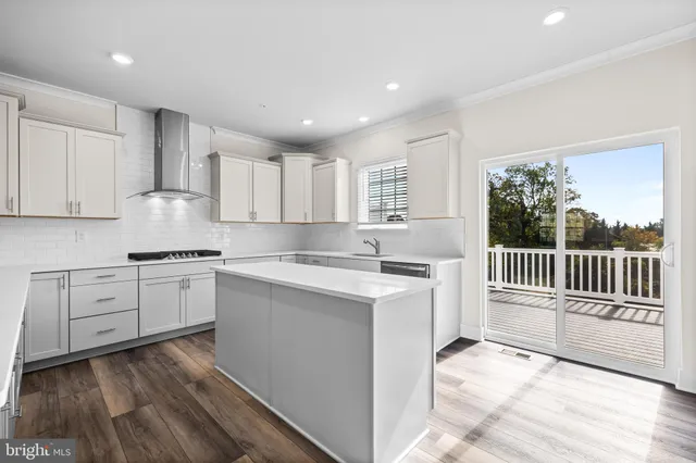 a kitchen with granite countertop a stove a sink and a refrigerator