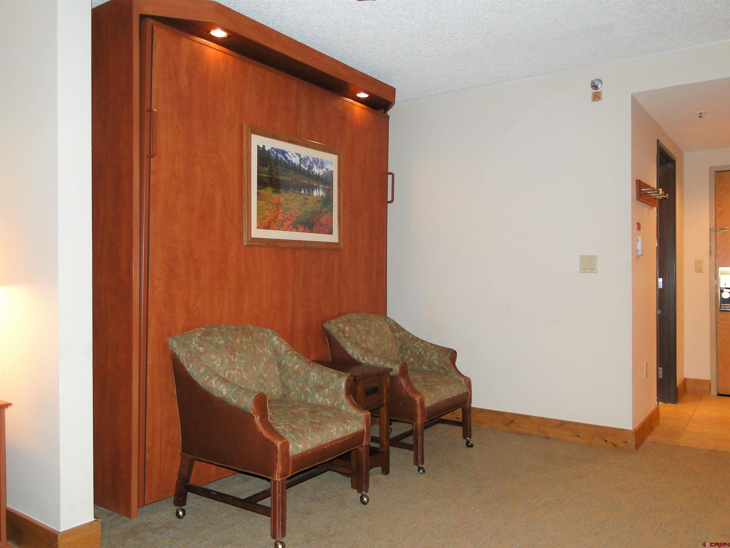 6 Emmons Road, Unit 122 Crested Butte, CO 81225 - Photo 14 of 19 a blue chair sitting in a room next to a window
