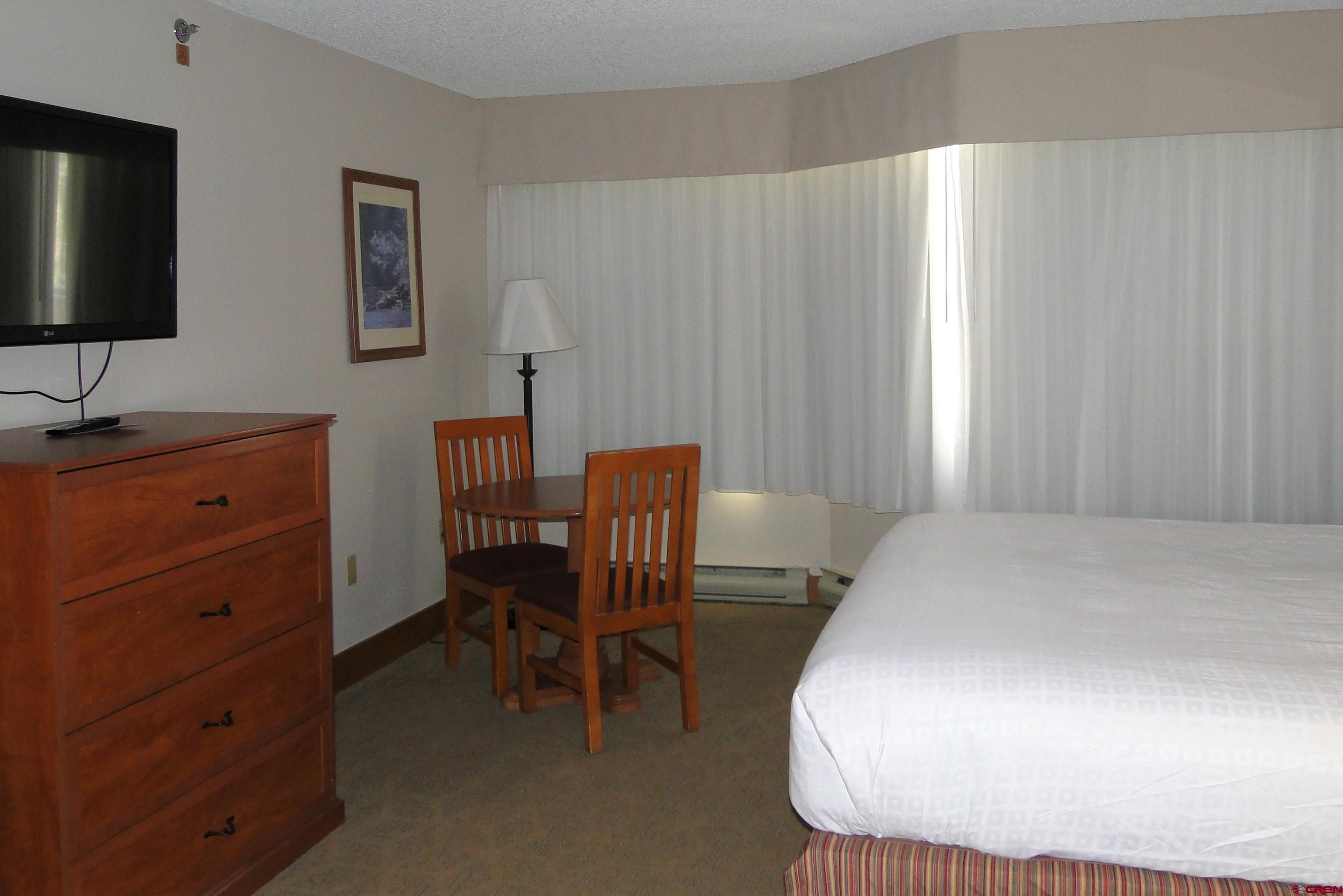 6 Emmons Road, Unit 122 Crested Butte, CO 81225 - Photo 17 of 19 a room with a chair and a dresser in it