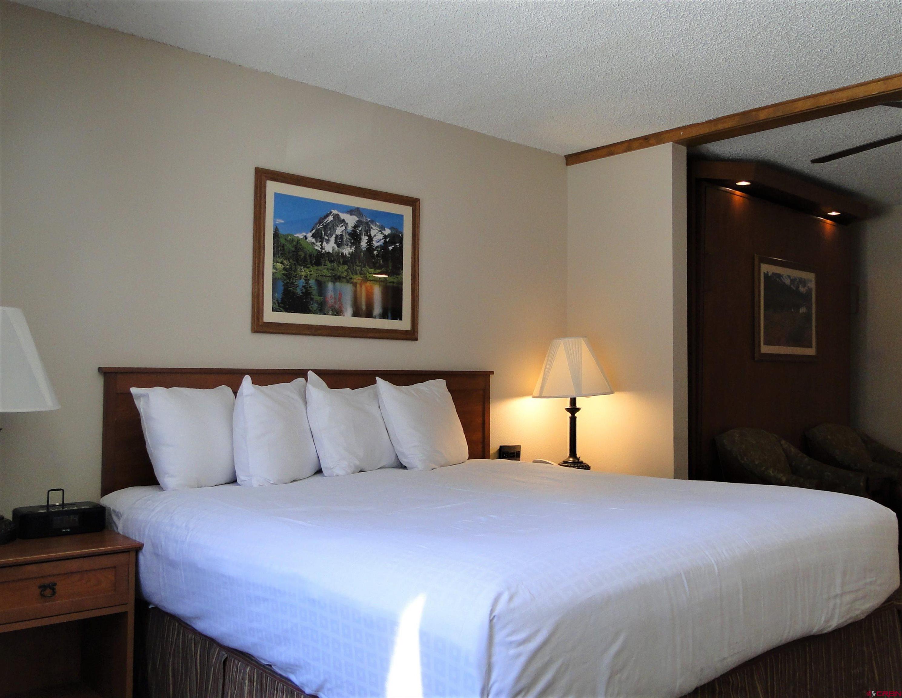 6 Emmons Road, Unit 122 Crested Butte, CO 81225 - Photo 18 of 19 a bedroom with a bed and a night stand