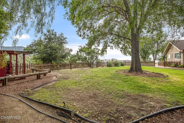 a kitchen with stainless steel appliances granite countertop a stove top oven a sink and a refrigerator