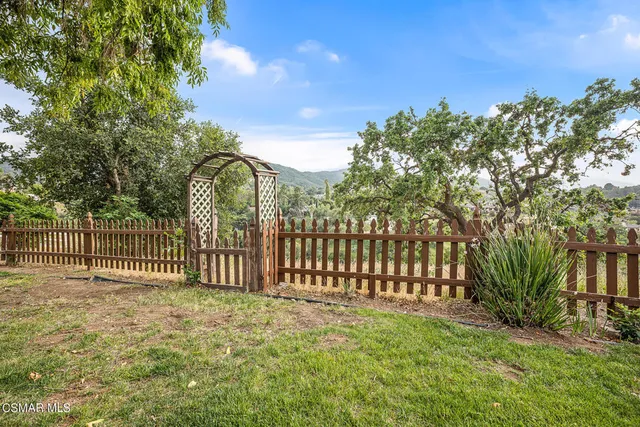 an empty room with floor to ceiling window and an outdoor view