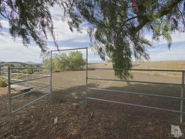 an empty room with a window and a ceiling fan