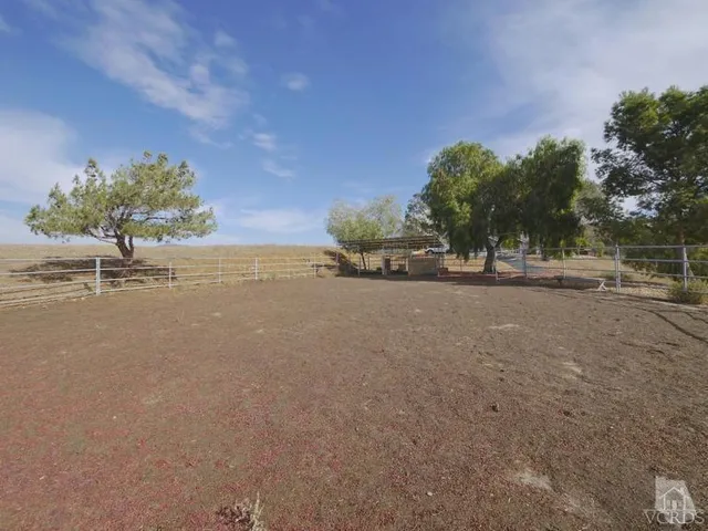 a kitchen with white cabinets and sink