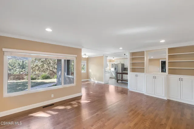 a dining room with furniture a chandelier and wooden floor