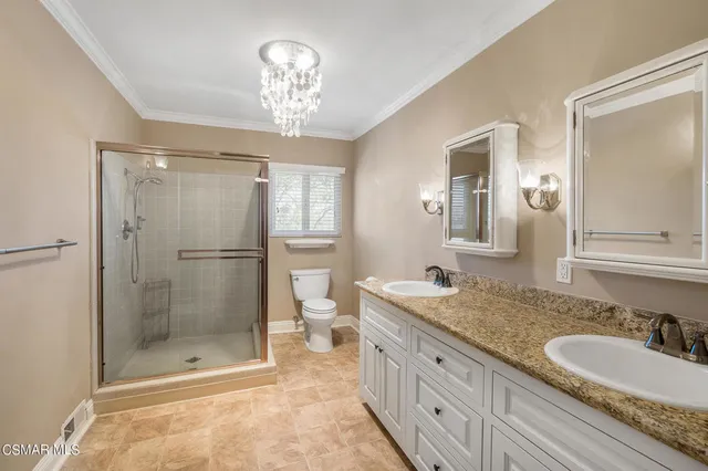 a backyard of a house with large trees and outdoor seating