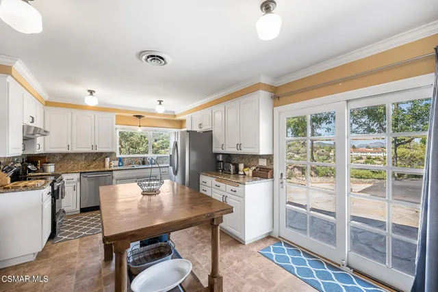 a view of a dry yard with wooden fence