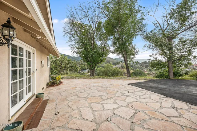 an aerial view of residential houses with outdoor space and trees
