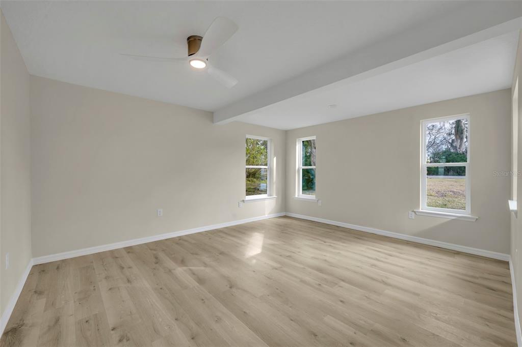 31201 Merry Road Tavares, FL 32778 - Photo 23 of 40 an empty room with wooden floor and windows