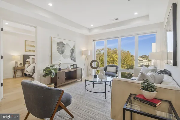 a living room with furniture fireplace and a large window