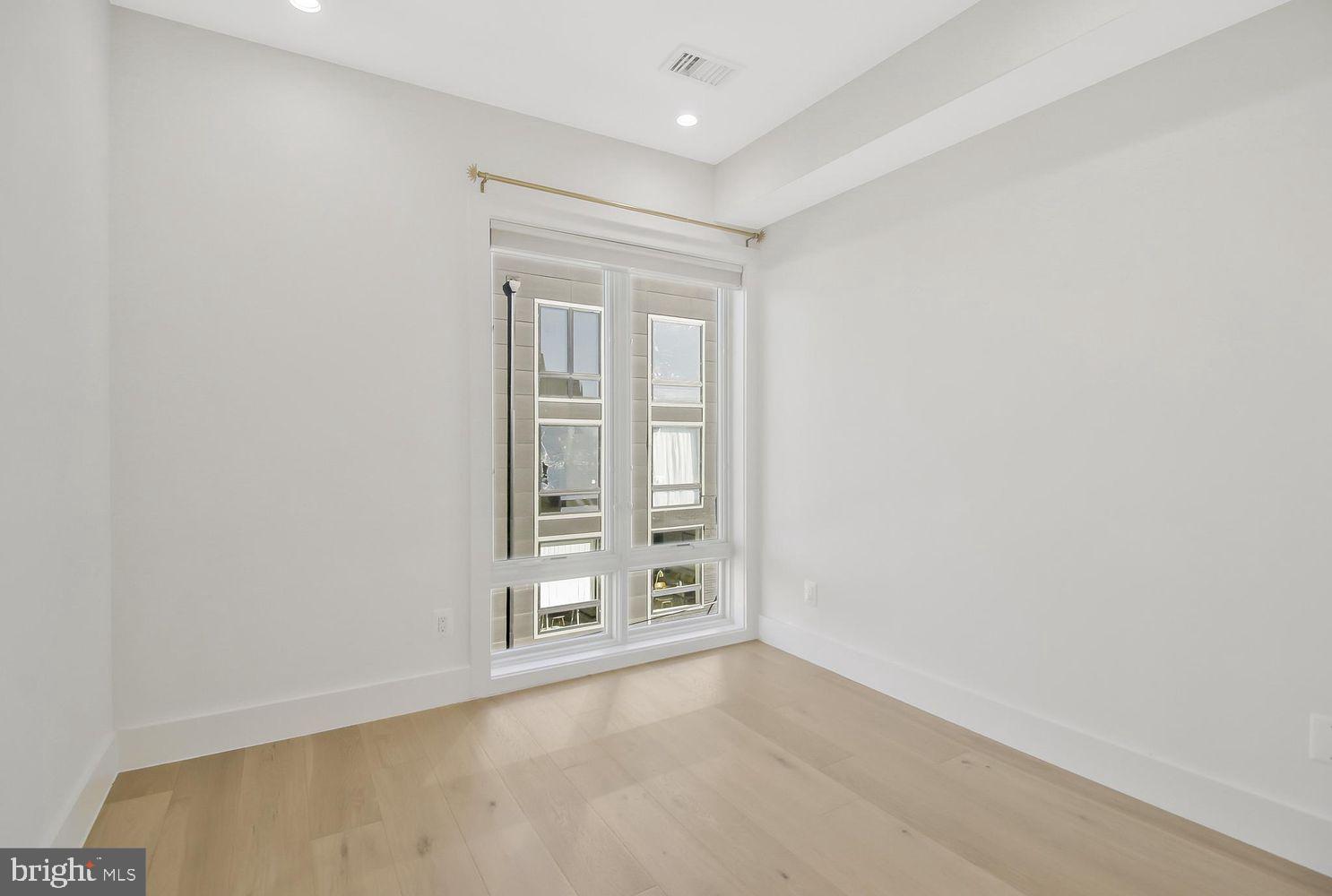 1654 K Street Northeast, Unit 8 Washington, DC 20002 - Photo 13 of 20 an empty room with windows