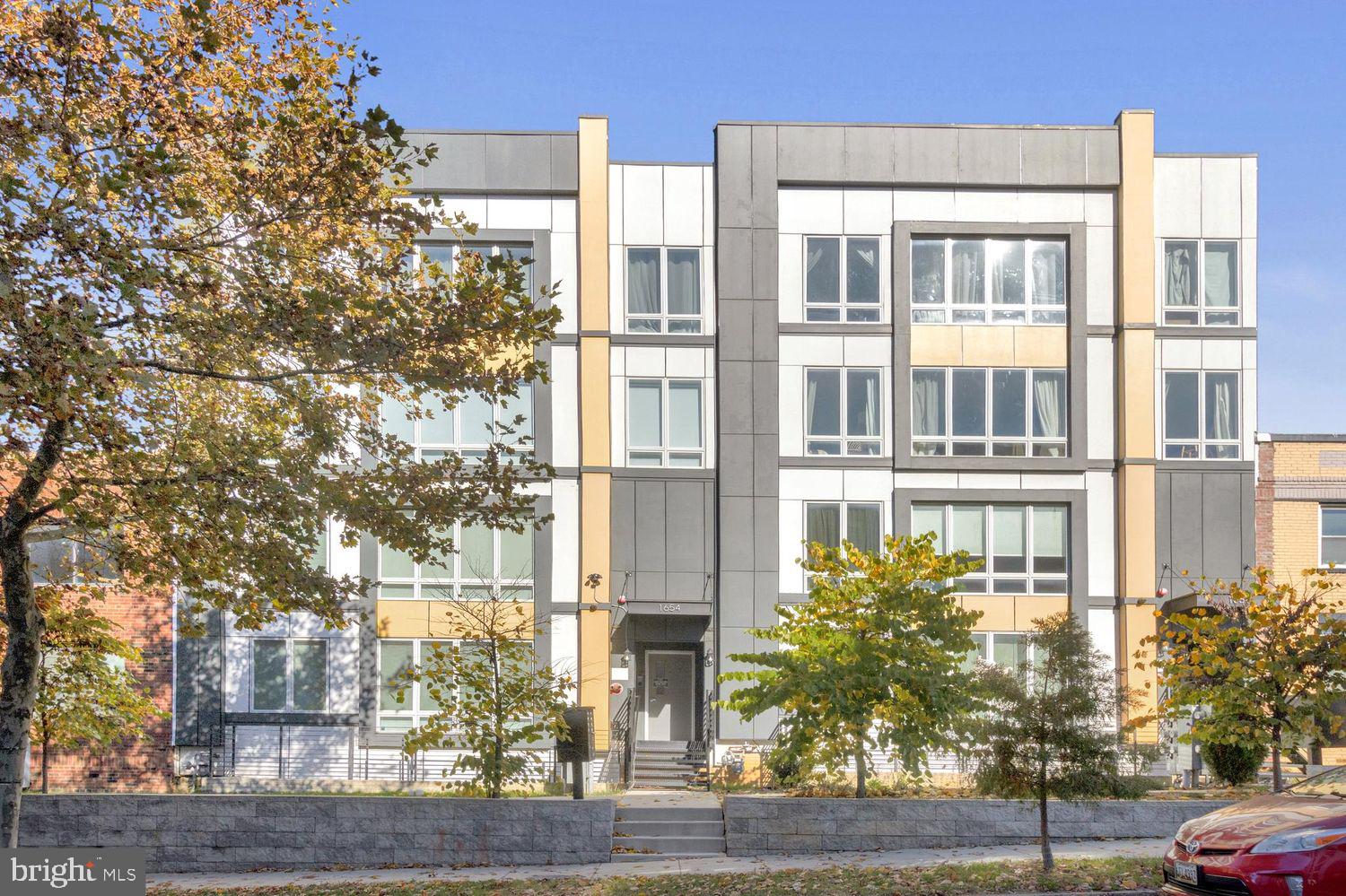 1654 K Street Northeast, Unit 8 Washington, DC 20002 - Photo 18 of 20 a front view of a residential apartment building with a yard