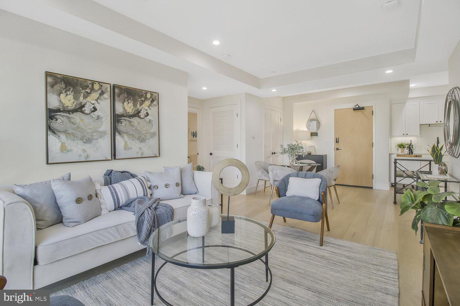 1654 K Street Northeast, Unit 8 Washington, DC 20002 - Photo 3 of 20 a living room with furniture and wooden floor