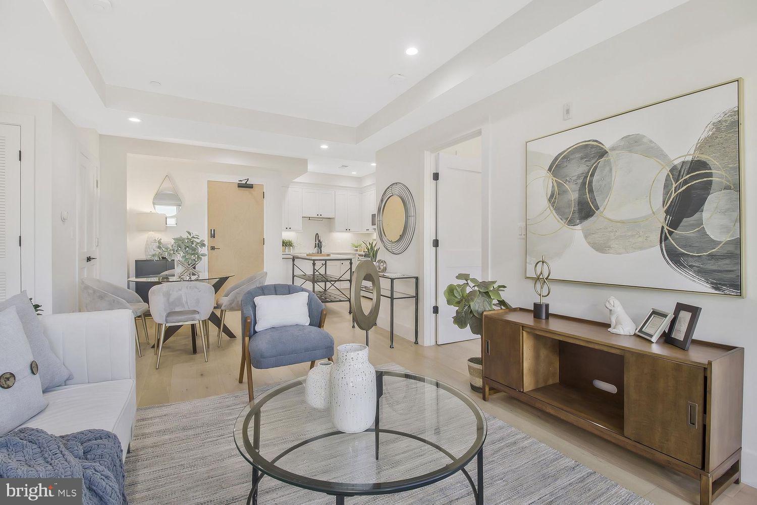 1654 K Street Northeast, Unit 8 Washington, DC 20002 - Photo 4 of 20 a living room with furniture a table and wooden floor