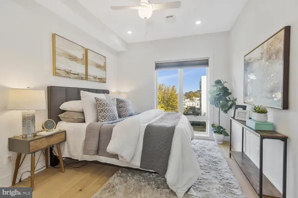 a bedroom with a balcony a bed and a chandelier