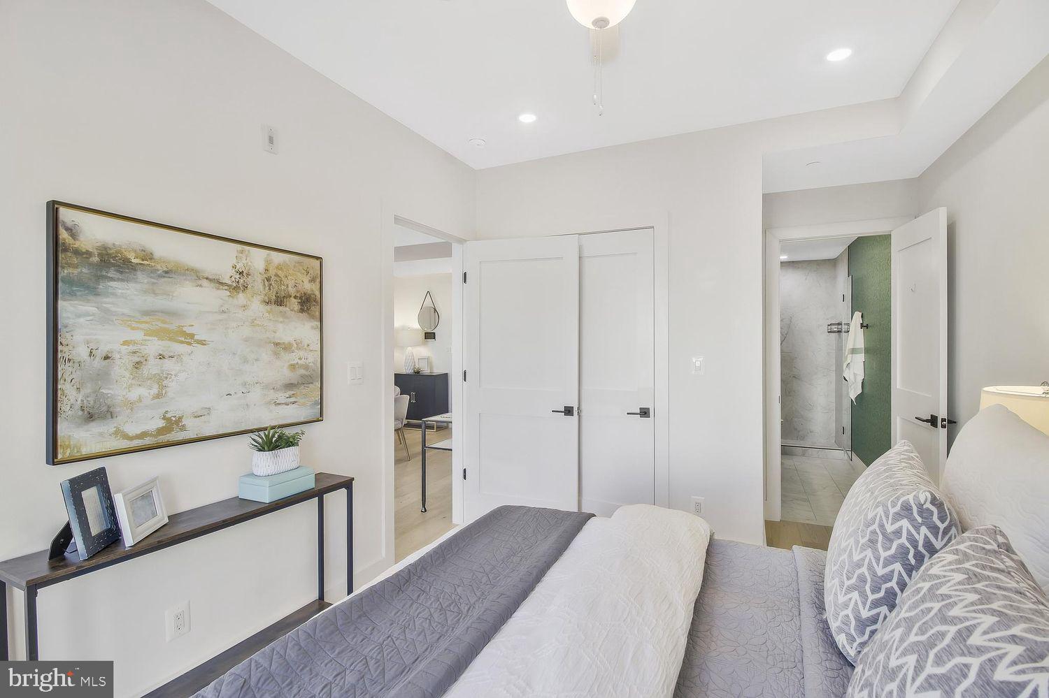 1654 K Street Northeast, Unit 8 Washington, DC 20002 - Photo 10 of 20 a bedroom with furniture and a painting on the wall