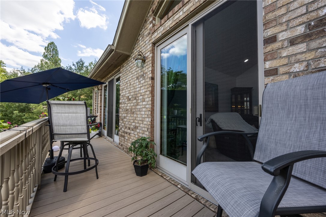 1602 Glendale Road, Unit 3 Marietta, OH 45750 - Photo 39 of 49 Spacious outdoor deck featuring composite decking, a traditional baluster railing, and a brick exterior facade
