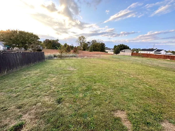 a view of a lake with houses in the back