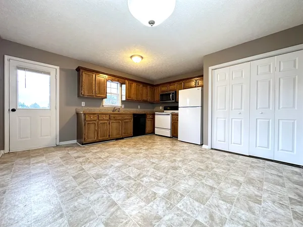 a view of a kitchen with a stove cabinets and a refrigerator