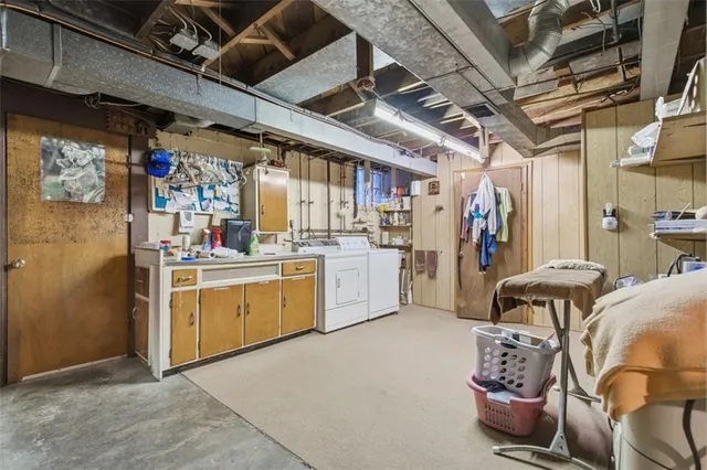 a utility room with cabinets dryer and washer