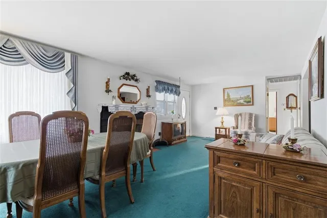 a bedroom with furniture and a mirror