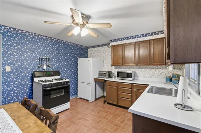 a kitchen with granite countertop stainless steel appliances and wooden cabinets