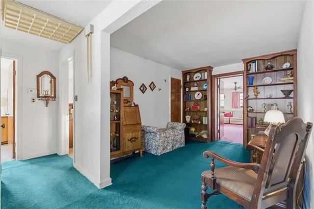 a living room with furniture and book shelf