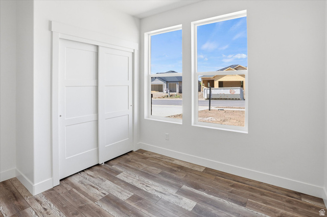 1315 West 3200 South, Unit 17 Perry, UT 84302 - Photo 21 of 58 Room featuring wood-finish flooring, white walls, and a white baseboard trim