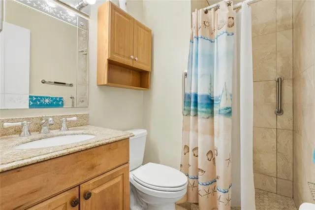 a bedroom with a bed and a lamp on dresser