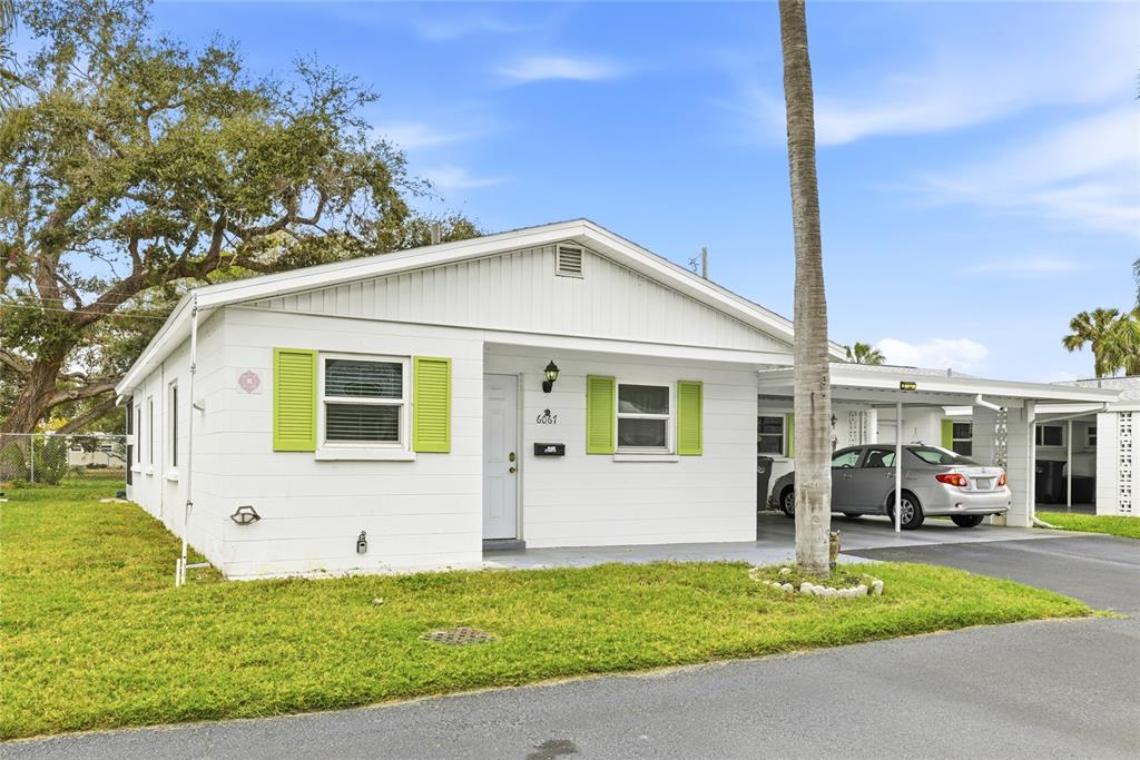 6067 Arlene Way, Unit 5 Bradenton, FL 34207 - Photo 2 of 25 a front view of a house with a yard