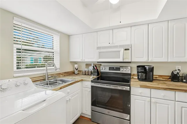 a kitchen with stainless steel appliances a stove a refrigerator and cabinets