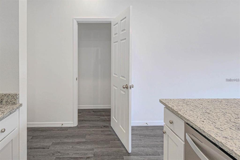 561 Wildmer Road Southwest Palm Bay, FL 32908 - Photo 4 of 19 an empty room with wooden floor