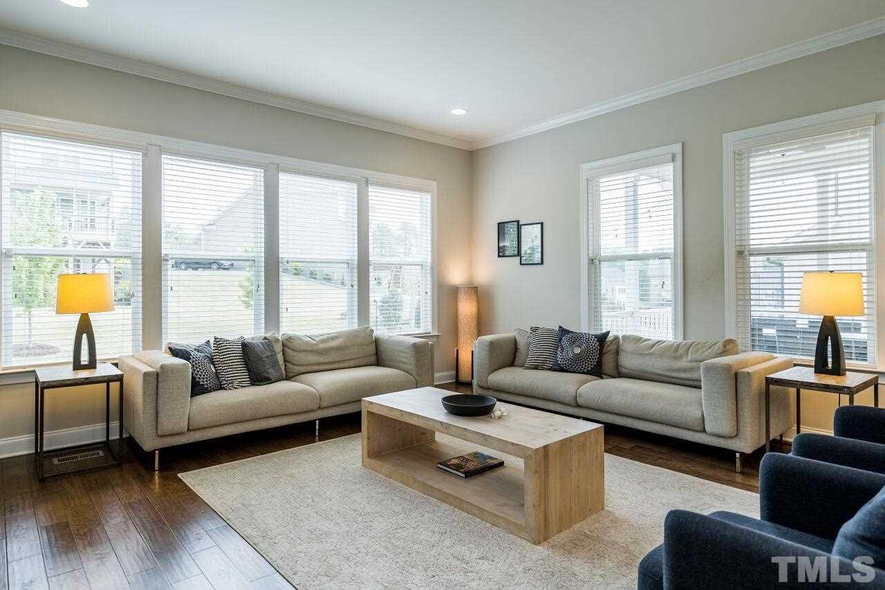 5264 Aleppo Lane Raleigh, NC 27613 - Photo 13 of 30 Recessed lighting, neutral paint and numerous windows in this living room.