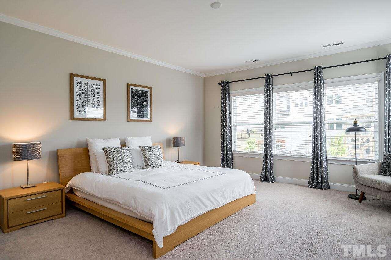 5264 Aleppo Lane Raleigh, NC 27613 - Photo 18 of 30 Upstairs owner's suite features expansive wall of windows and huge en suite bath.