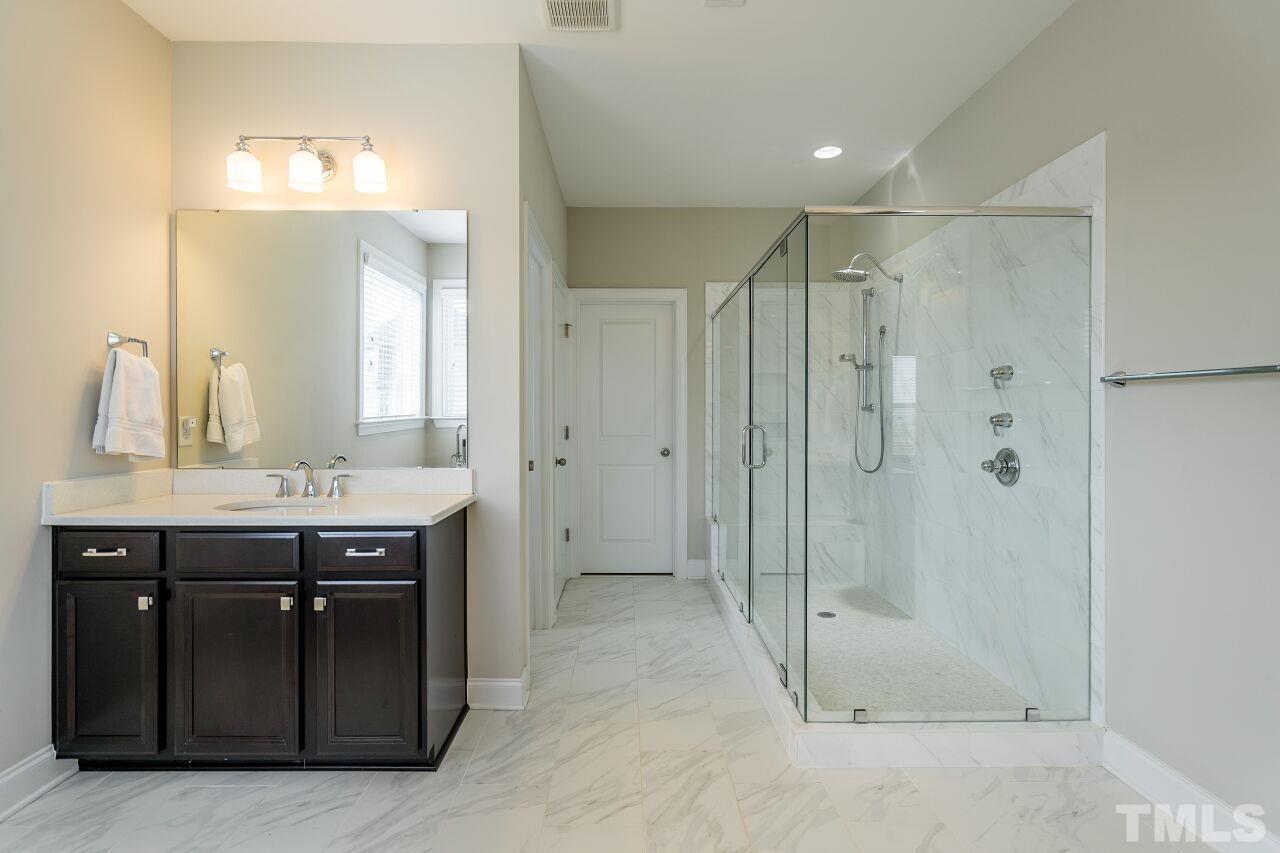 5264 Aleppo Lane Raleigh, NC 27613 - Photo 21 of 30 Sleek tile gives a glamorous look to this open bath.